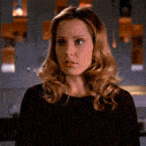 a woman with blonde hair wearing a black shirt