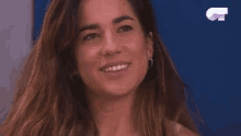 a close up of a woman laughing with a g on the bottom right