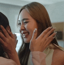 two women are hugging each other and one of them is laughing