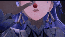 a close up of a girl 's face with a red cherry in her nose
