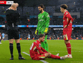 a soccer player with the number 10 on his jersey is laying on the field