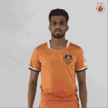 a man wearing an orange shirt that says ' ii ' on it