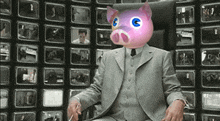a man in a suit with a pink pig head