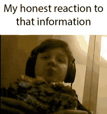 a boy wearing headphones is eating a large piece of pizza