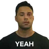 a man wearing a black shirt that says yeah on it