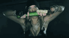 a woman is holding a cucumber in her mouth that has the word carnage on it