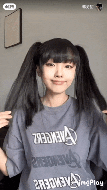 a woman is wearing a t-shirt that says avengers