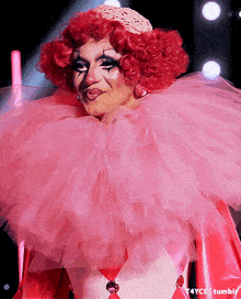 a drag queen in a pink harlequin costume with t4yce tumblr in the bottom right corner