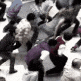 a group of people are standing in a circle on the ground .