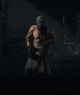 a man without a shirt is wearing a mask and holding a sword
