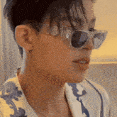 a close up of a person 's face wearing sunglasses