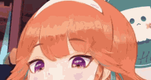 a close up of a girl 's face with purple eyes .