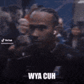 a blurry picture of a man with the words " wya cuh " on the bottom