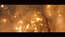 a close up of a fire with a lot of flames and smoke