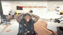 a man is sitting in a chair with his hands on his head while wearing headphones .