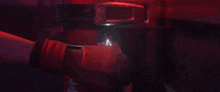 a person is holding a red light in their hand .