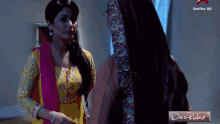 two women are standing next to each other in front of a star plus hd sign