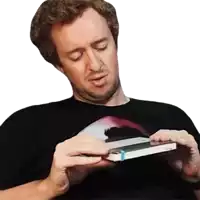 a man wearing a black shirt is holding a book