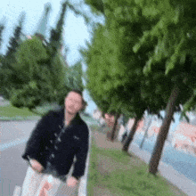 a blurry picture of a man riding a scooter on a sidewalk
