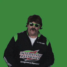 a man wearing a jacket that says interstate batteries
