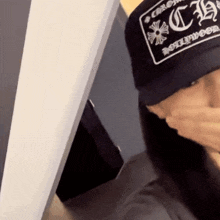 a person wearing a hat that says chrome hearts