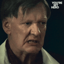 a close up of a man 's face with the words " you 're my hero " on the bottom