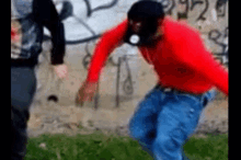 a man wearing a gas mask is running in front of a wall with graffiti .