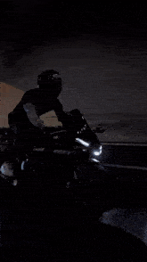 a man wearing a shoe helmet is sitting on a motorcycle