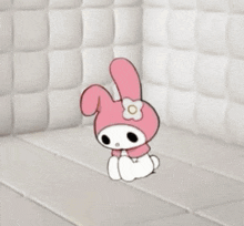 a man in a white jacket is sitting on a white bed