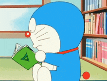 doraemon is reading a book with a green triangle on it