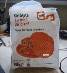 a package of pizza flavored crackers is sitting on a desk
