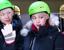 a person wearing a green helmet that says turn