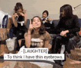 a group of women are sitting on a couch and one of them is saying laughter to think i have thin eyebrows .
