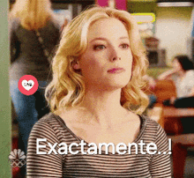 a woman wearing a striped shirt with the words exactamente written on it