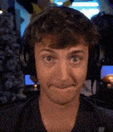 a man wearing headphones makes a funny face