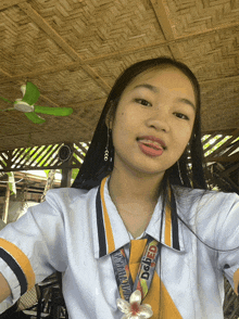 a girl with a lanyard around her neck that says dsfed