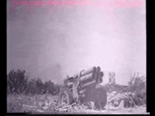 a black and white photo of a military vehicle shooting a rocket .