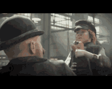 a man in a bowler hat talks to a woman in a hat