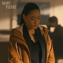 a woman in a brown jacket with the word saint-pierre on the bottom