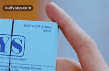 a close up of a person holding a blue business card