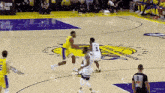 a group of basketball players are playing a game of basketball on a basketball court .