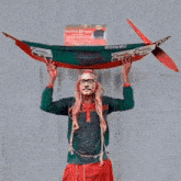 a man is holding a boat on his head with a sign behind him that says 075853 8170