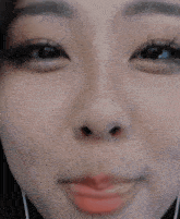 a close up of a woman 's face with a red lip