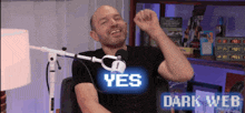 a man wearing a black shirt that says yes