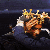 a man wearing a crown with the word cx7 on the bottom