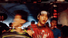 a blurry picture of a man wearing a red shirt that says ' i love you '