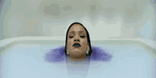 a woman is sitting in a bathtub with the words work , work , work , work