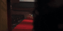 a cartoon character in a top hat and bow tie is kneeling down on a red carpet