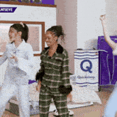 two women dancing in front of a quicksleep box