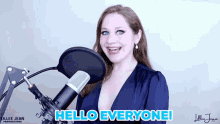 a woman stands in front of a microphone with the words hello everyone on the bottom